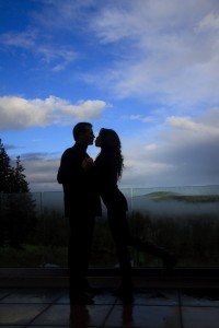 a photo of a couple silhouetted against a blue sky
